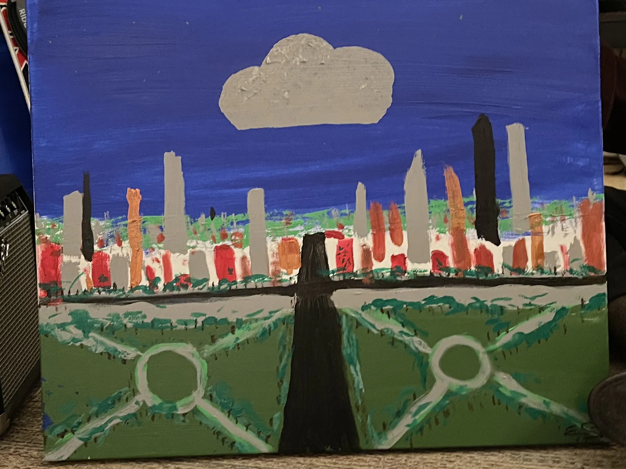 City skyline beyond a green park beneath a deep blue sky