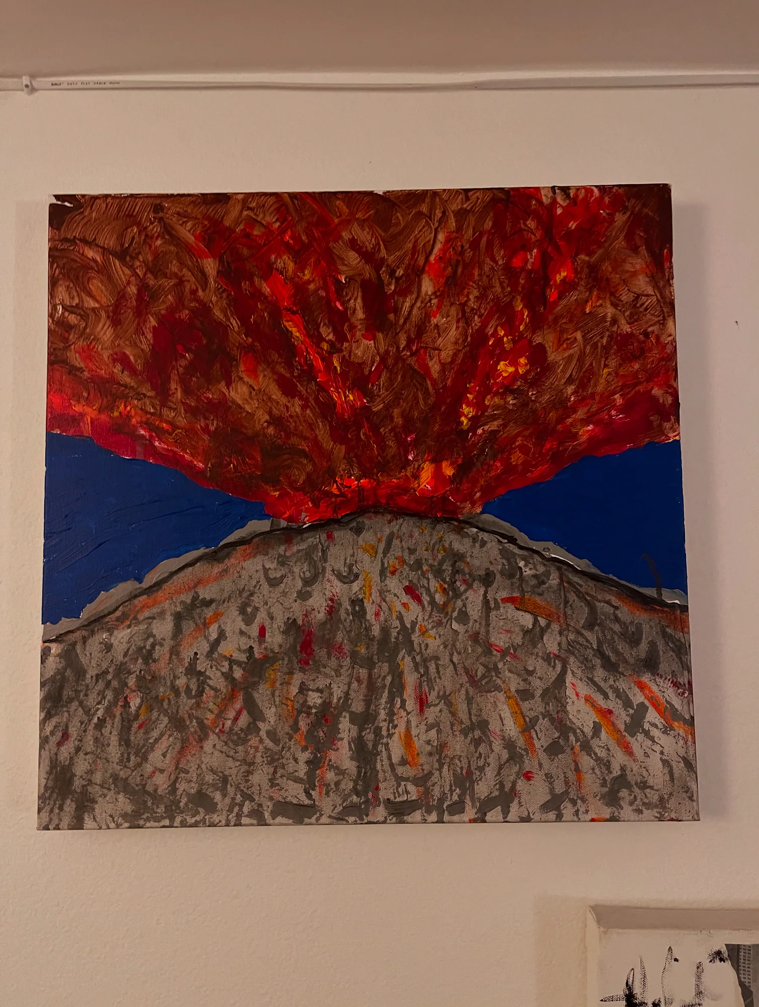 Volcano erupting in red and orange above a textured gray slope