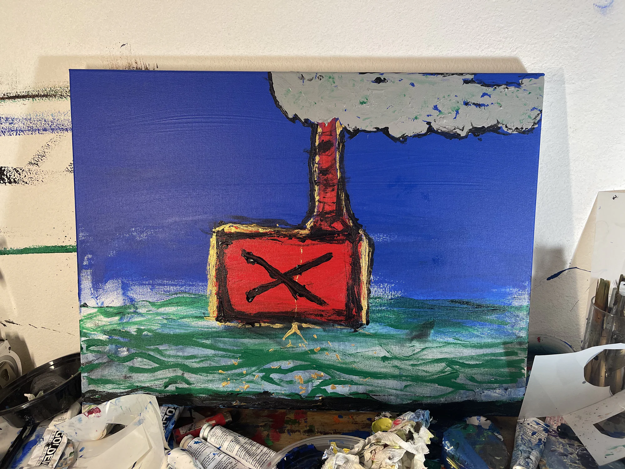 Red buoy floating on green-blue water beneath a gray cloud