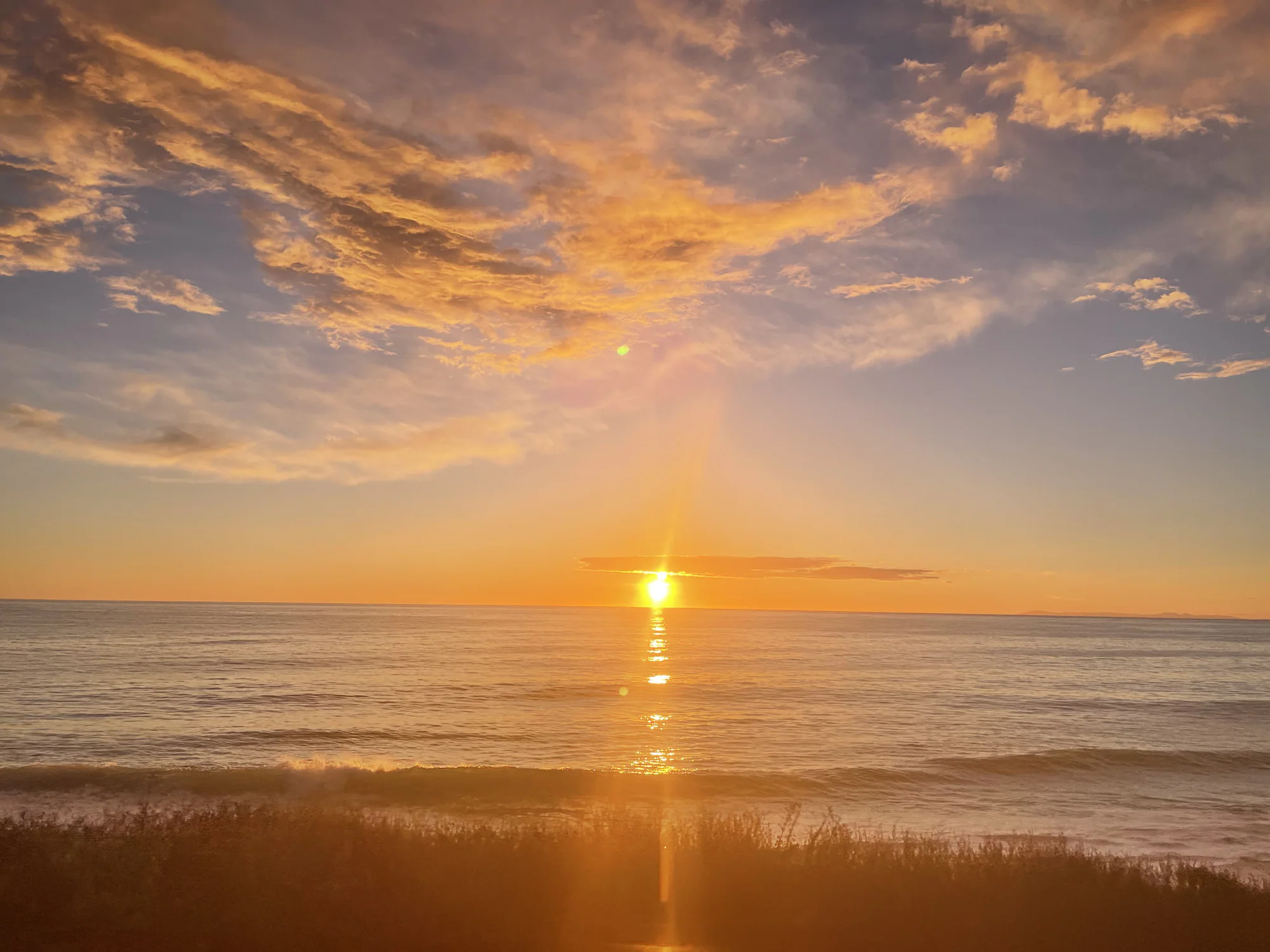 Golden light reflected across water